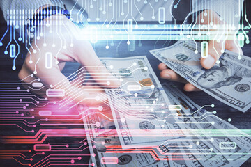 Double exposure of technology drawing hologram and us dollars bills and man hands. Data concept