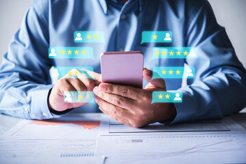 businessman using smartphone views the feedback from customer. hand holding smartphone with 1-5 star rating on screen, customer satification concept