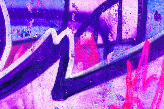 Fototapeta Closeup of colorful pink, purple, blue urban wall texture. Modern pattern for wallpaper design. Creative modern urban city background for advertising mockups. Grunge messy street style background