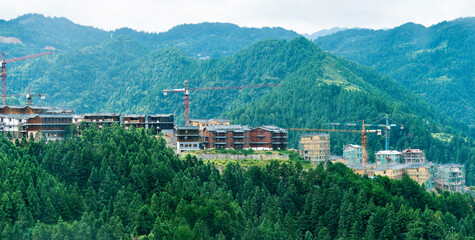Naklejka premium Construction site with crane on mountain range