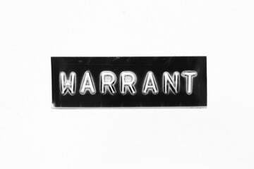 Black color banner that have embossed letter with word warrant on white paper background