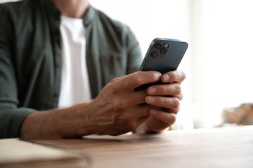 Close up of male hands with mobile. Man pointing on smartphone screen, chatting in social networks