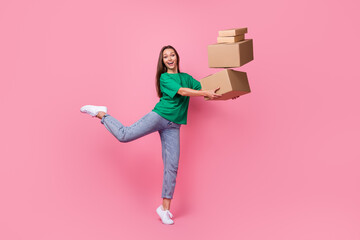 Full length portrait of cheerful crazy person arms hold pile stack packages isolated on pink color...
