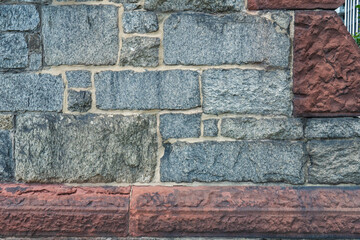 heavy stone blocks and mortar on the foundation of a historic church building with unique architectural features