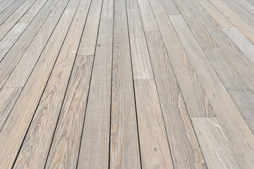 Raw lumber boards milled into 2x4 make up the floor planks of an outdoor deck despite high material costs