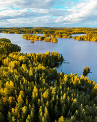 Autumn foliage colored trees, lake house and islands in Heinola, Finland