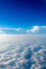 Blue sky and white cloud from airplane window