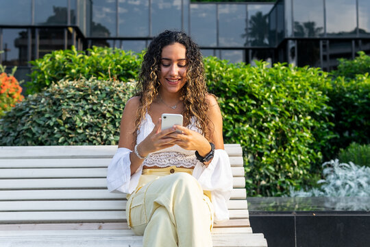 Young woman on smartphone in park