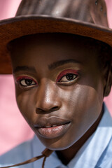 Close-up of an African girl. Portrait of a beautiful face. Wearing hat.