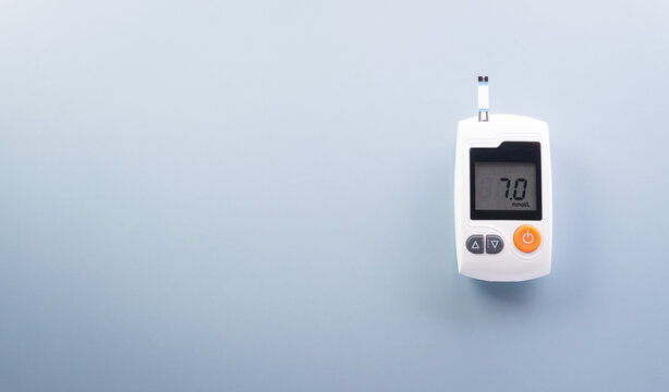 World Diabetes day concept ,14 November. Top view of blood glucose meter sets on pastel blue background,