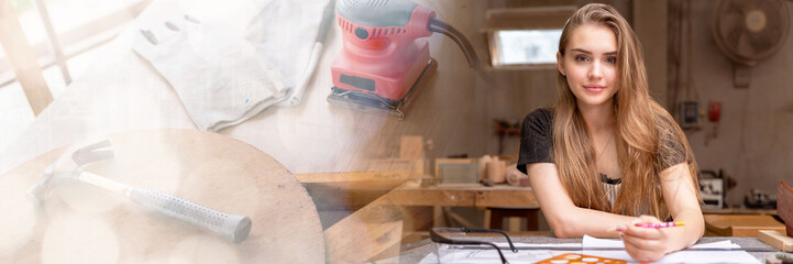 Web banner Portrait of a female carpenter drawing on paper for designing and building furniture in a furniture factory. with modern tools with copy space on left