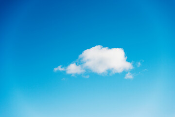 Single white cloud in the blue sky