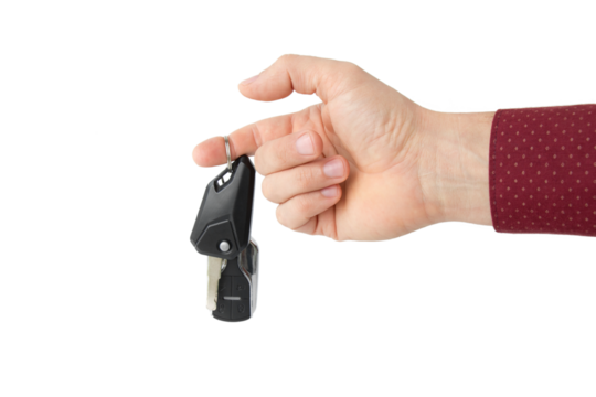 Hand with car key, isolated 