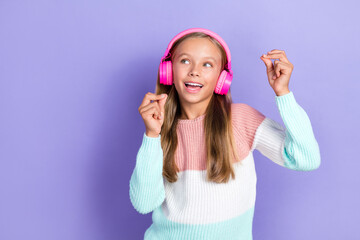 Obraz na płótnie Canvas Photo of positive cool girl meloman look empty space promo sale shop modern technology ear accessory isolated on purple color background