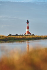 Fototapeta na wymiar Lighthouse in salt marsh in northern Germany. High quality photo