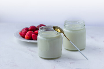 Healthy food at home. Homemade yogurt with strawberries in glass jars