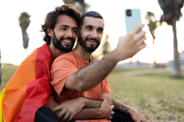 Happy couple with a pride flag. LGBT community.