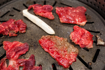 Fresh red beef meat and mushroom cooking on a hot iron plate, Ulleungdo Island, restaurant in South Korea