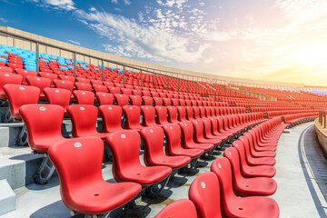 Naklejka premium Red seats and beautiful sky clouds in the stadium