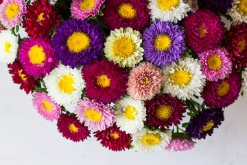 Bouquet of small colorful chrysanthemums. Bouquet in the shape of a basket. Top view