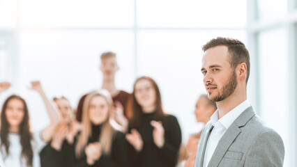 side view. a young speaker standing in the conference room.