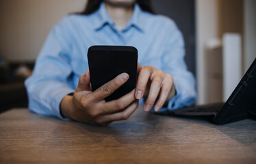 Businessman hands working with finances about cost and calculator and laptop with tablet, smartphone at office in morning light