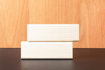 Two wooden blocks with a place to insert text on a light wooden background