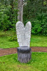 scenery for a photo zone angel wings on a tree stump seat for a photo
