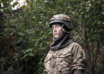 Obraz premium Sad woman soldier in uniform
