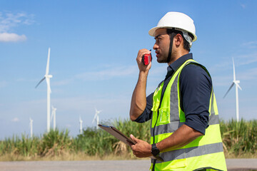 engineer team working in wind turbine farm. Renewable energy with wind generator by alternative energy concept.