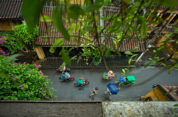 Tourists walking in Hoi An when it rains
