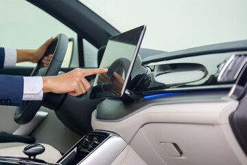 male businessman hand It's hitting the touch screen of modern technology in your car.