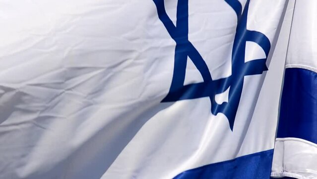 The flag of Israel against the background of the blue