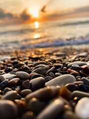 Obraz premium View of the sea and sun rising above the stones in Cirali, Antalya, Turkey. Selective focus.