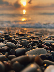 Obraz premium View of the sea and sun rising above the stones in Cirali, Antalya, Turkey. Selective focus.