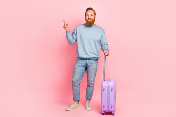 Full size photo of cheerful positive man direct finger empty space blank isolated on pink color background