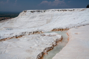 Pamukkale landsape. White terraces with natural travertines in Pamukkale. Amazing scenery of calcium mountains in Turkey