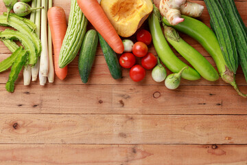 Thai kitchen Menu Concept. Various vegetables, spices and Ingredients with blank note page and pencil on wooden background. Top view with copy space
