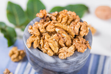 Мarble bowl filled with shelled walnuts