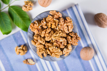 Мarble bowl filled with shelled walnuts
