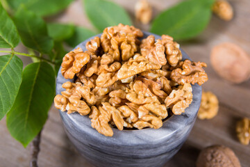 Мarble bowl filled with shelled walnuts