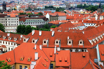 Fototapeta na wymiar Prague, Czech Republic. Mala Strana, Lesser Town of Praha. Top view, panorama. Ancient old house with red tiled roofs, tower, castle