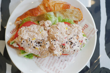 Tuna sandwich with mayonnaise on a plate on table 