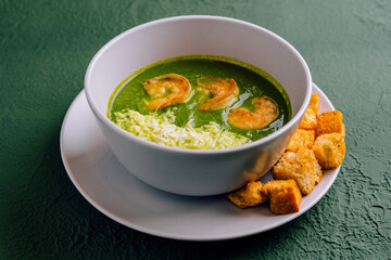 Broccoli green cream soup with shrimps
