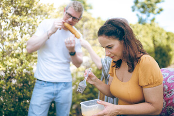 Fototapeta premium Happy family cheering with barbecue dinner outdoor - Group of people having fun at weekend meal - BBQ Food, taste and summer concept, Man cooking meat on barbecue grill at summer party