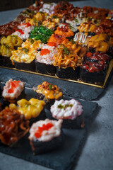 Sushi is a Japanese dish of prepared vinegared rice (鮨飯, sushi-meshi), usually with some sugar and salt, accompanied by a variety of ingredients