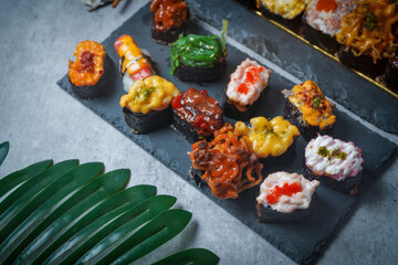 Sushi is a Japanese dish of prepared vinegared rice (鮨飯, sushi-meshi), usually with some sugar and salt, accompanied by a variety of ingredients