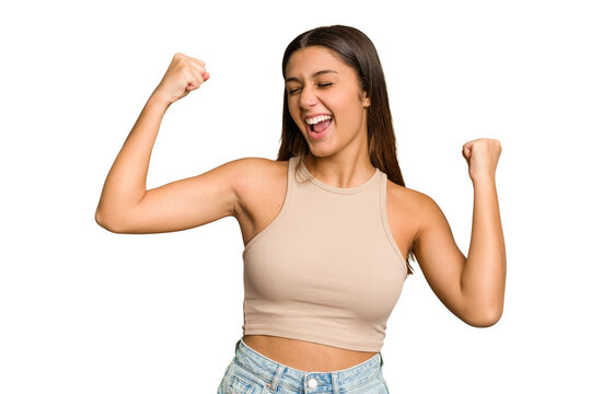 Young Indian woman isolated cutout removal background raising fist after a victory, winner concept.
