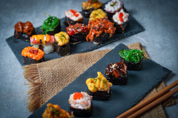 Sushi is a Japanese dish of prepared vinegared rice (鮨飯, sushi-meshi), usually with some sugar and salt, accompanied by a variety of ingredients