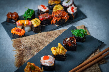Sushi is a Japanese dish of prepared vinegared rice (鮨飯, sushi-meshi), usually with some sugar and salt, accompanied by a variety of ingredients